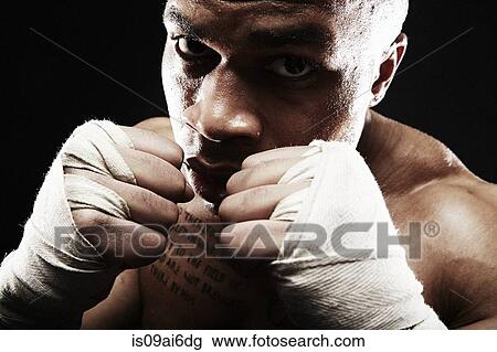 Stock Image - Mid adult man boxing, close up. Fotosearch