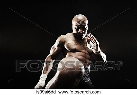 Mid adult man kickboxing View Large Photo Image Stock Image - Mid adult man kickboxing. Fotosearch