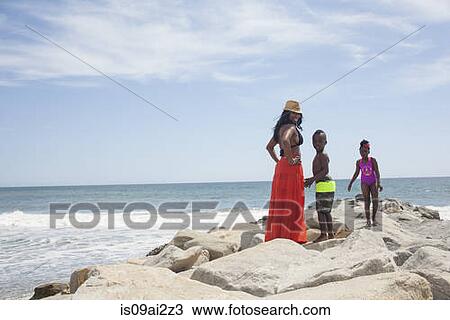 Mother and children enjoying ocean View Large Photo Image Stock Image - Mother and children enjoying ocean. Fotosearch
