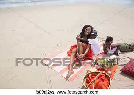 Mother and children relaxing on beach View Large Photo Image Stock Photograph - Mother and children relaxing on beach. Fotosearch