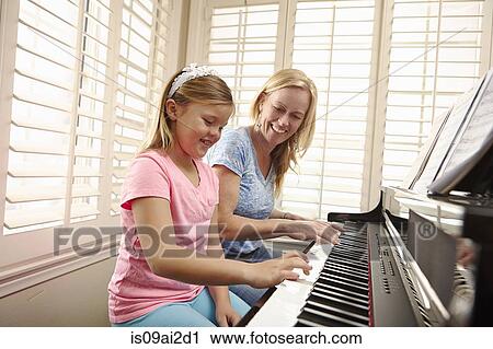 Mother and daughter playing piano View Large Photo Image Stock Image - Mother and daughter playing piano. Fotosearch