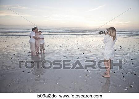 Photographer taking family portrait on beach, Cape Town, South Africa View Large Photo Image Picture - Photographer taking family portrait on beach, Cape Town, South Africa. Fotosearch