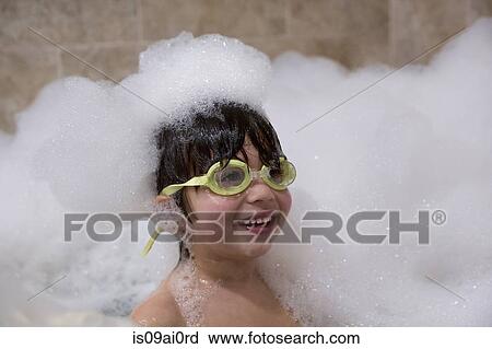 Portrait of young boy wearing goggles in bubble bath View Large Photo Image Stock Image - Portrait of young boy wearing goggles in bubble bath. Fotosearch