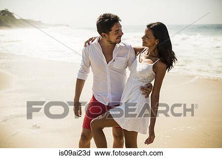 Stock Image - Romantic couple, Arpoador beach, Rio De Janeiro, Brazil. Fotosearch