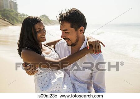 Stock Image - Romantic couple on Arpoador beach, Rio De Janeiro, Brazil. Fotosearch