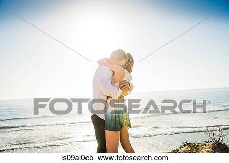 Romantic young couple hugging each other at coast View Large Photo Image Stock Image - Romantic young couple hugging each other at coast. Fotosearch