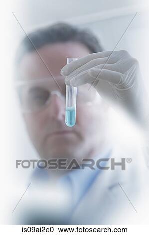 Scientist looking at test tube View Large Photo Image Stock Image - Scientist looking at test tube. Fotosearch