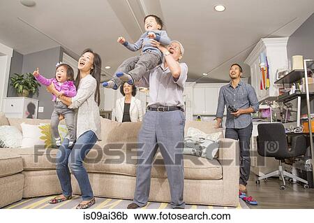 Three generation family having fun in sitting room View Large Photo Image Stock Image - Three generation family having fun in sitting room. Fotosearch