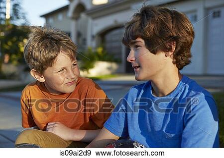 Two boys talking View Large Photo Image Stock Photo - Two boys talking. Fotosearch