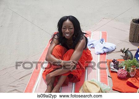 Stock Photography - Woman relaxing on beach. Fotosearch