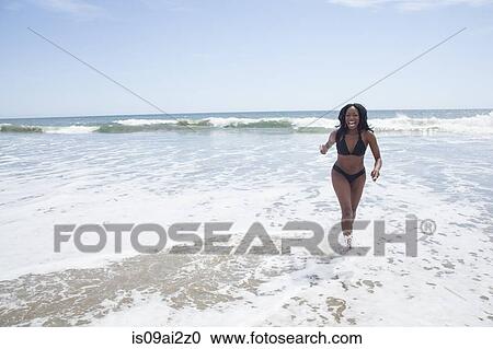 Woman walking on beach View Large Photo Image Stock Image - Woman walking on beach. Fotosearch