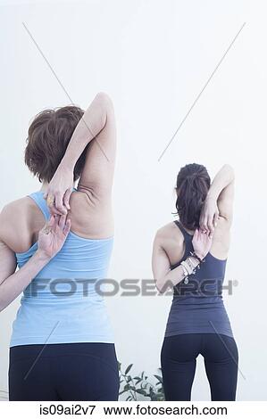 Women doing shoulder stretches View Large Photo Image Stock Photo - Women doing shoulder stretches. Fotosearch