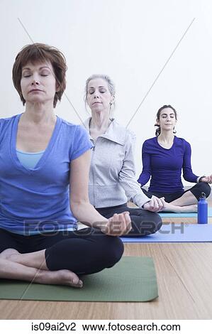 Women in lotus pose View Large Photo Image Stock Image - Women in lotus pose. Fotosearch