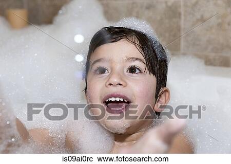 Young boy trying to catch bubble in bubble bath View Large Photo Image Stock Image - Young boy trying to catch bubble in bubble bath. Fotosearch