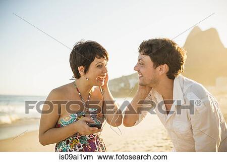 Young couple enjoying sunset, Ipanema Beach, Rio, Brazil View Large Photo Image Picture - Young couple enjoying sunset, Ipanema Beach, Rio, Brazil. Fotosearch