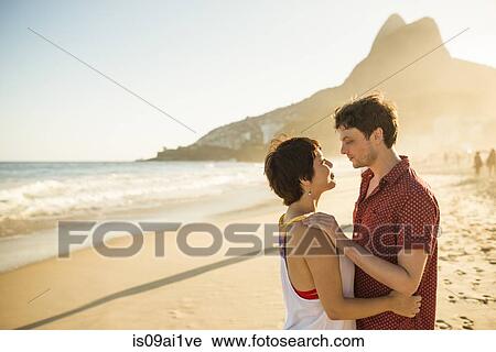 Young couple hugging at sunset, Ipanema Beach, Rio, Brazil View Large Photo Image Stock Image - Young couple hugging at sunset, Ipanema Beach, Rio, Brazil. Fotosearch