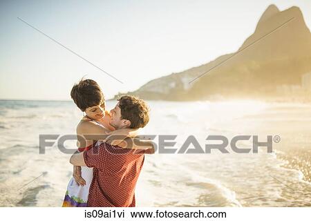 Young couple hugging at sunset, Ipanema Beach, Rio, Brazil View Large Photo Image Stock Image - Young couple hugging at sunset, Ipanema Beach, Rio, Brazil. Fotosearch