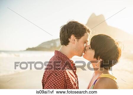 Young couple kissing at sunset, Ipanema Beach, Rio, Brazil View Large Photo Image Stock Image - Young couple kissing at sunset, Ipanema Beach, Rio, Brazil. Fotosearch