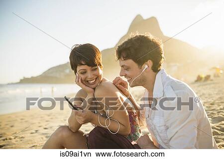 Young couple listening to music, Ipanema Beach, Rio, Brazil View Large Photo Image Picture - Young couple listening to music, Ipanema Beach, Rio, Brazil. Fotosearch