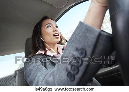 Young female businesswoman driving car View Large Photo Image Stock Photography - Young female businesswoman driving car. Fotosearch