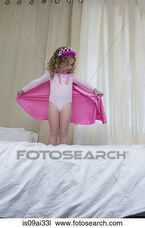 Young girl dressed up as a princess standing on bed View Large Photo Image Stock Image - Young girl dressed up as a princess standing on bed. Fotosearch