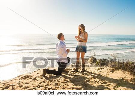 Young man proposing to girlfriend on beach, Torrey Pines, San Diego, California, USA View Large Photo Image Stock Image - Young man proposing to girlfriend on beach, Torrey Pines, San Diego, California, USA. Fotosearch