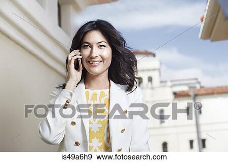 Young woman chatting on smartphone View Large Photo Image Stock Photo - Young woman chatting on smartphone. Fotosearch