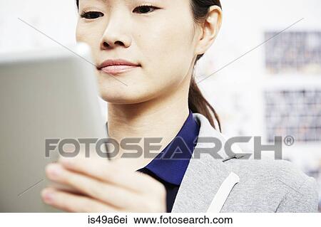 Young woman holding digital tablet View Large Photo Image Stock Image - Young woman holding digital tablet. Fotosearch
