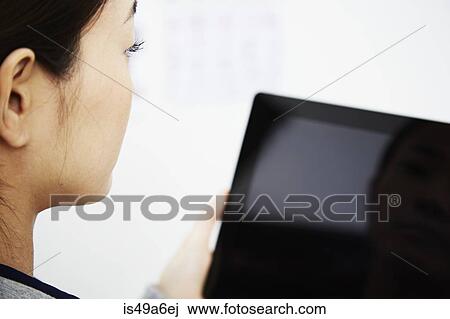 Young woman holding digital tablet View Large Photo Image Stock Image - Young woman holding digital tablet. Fotosearch