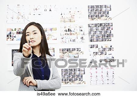 Stock Image - Young woman in creative studio. Fotosearch
