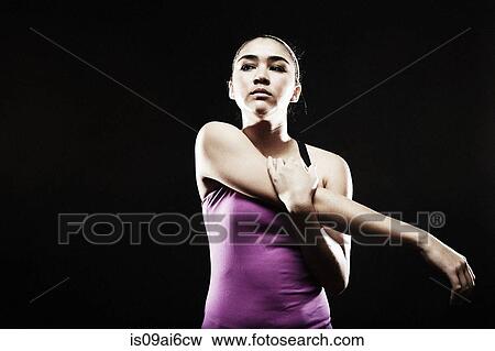 Young woman stretching arm View Large Photo Image Stock Photo - Young woman stretching arm. Fotosearch