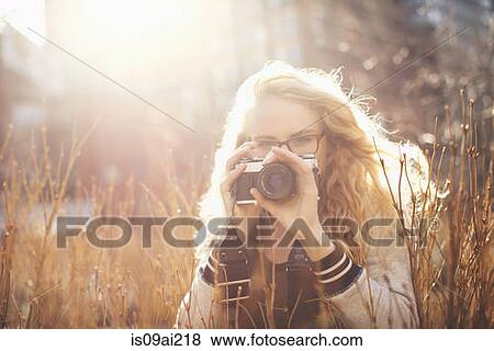 Young woman taking photograph View Large Photo Image Stock Photo - Young woman taking photograph. Fotosearch