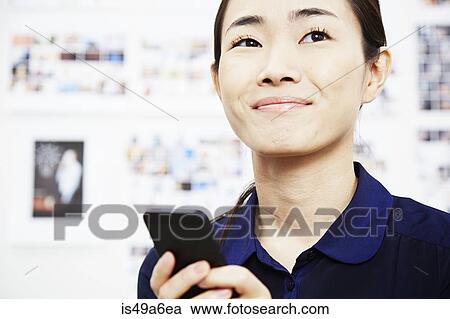 Young woman using smartphone View Large Photo Image Stock Image - Young woman using smartphone. Fotosearch