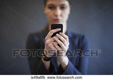 Young woman using smartphone View Large Photo Image Stock Image - Young woman using smartphone. Fotosearch