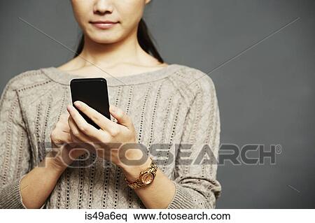 Young woman using smartphone View Large Photo Image Stock Photography - Young woman using smartphone. Fotosearch