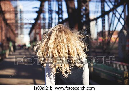 Young woman walking over bridge View Large Photo Image Stock Image - Young woman walking over bridge. Fotosearch