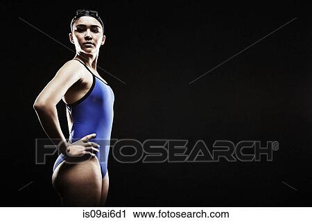 Young woman wearing blue swimsuit View Large Photo Image Stock Image - Young woman wearing blue swimsuit. Fotosearch