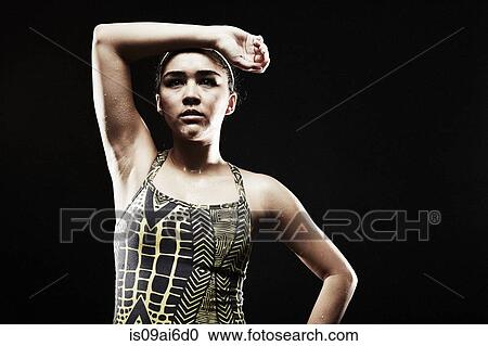 Young woman with arm on forehead View Large Photo Image Stock Image - Young woman with arm on forehead. Fotosearch