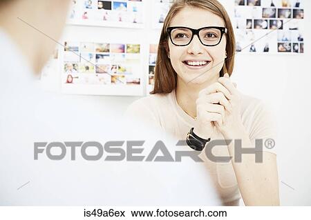 Young woman with colleague in creative studio View Large Photo Image Stock Photo - Young woman with colleague in creative studio. Fotosearch