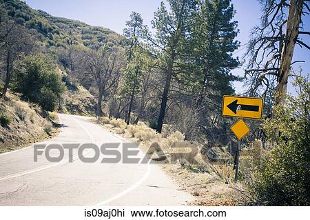 Arrow sign on bendy road, Lake Arrowhead, California, USA View Large Photo Image Stock Image - Arrow sign on bendy road, Lake Arrowhead, California, USA. Fotosearch