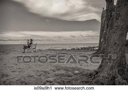 Black and white image of father and toddler daughter on beach bench View Large Photo Image Stock Image - Black and white image of father and toddler daughter on beach bench. Fotosearch
