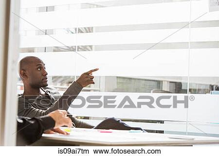 Businessman pointing finger in office View Large Photo Image Picture - Businessman pointing finger in office. Fotosearch
