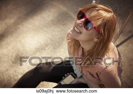 Candid portrait of mid adult woman in sunglasses gazing upward View Large Photo Image Stock Image - Candid portrait of mid adult woman in sunglasses gazing upward. Fotosearch