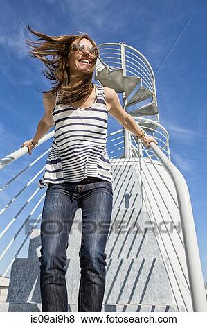 Candid portrait of mid adult woman on spiral staircase View Large Photo Image Stock Photo - Candid portrait of mid adult woman on spiral staircase. Fotosearch