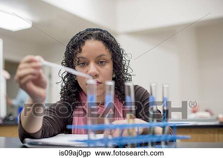Stock Photography - Chemistry student using pipette. Fotosearch