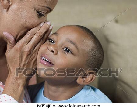 Close up of mature mother whispering to son View Large Photo Image Stock Image - Close up of mature mother whispering to son. Fotosearch