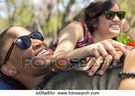 Close up of young couple reclining in woodland View Large Photo Image Picture - Close up of young couple reclining in woodland. Fotosearch