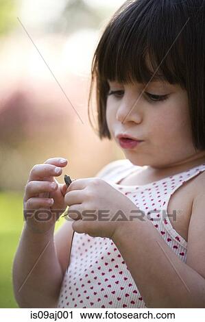 Close up portrait of girl holding lizard in garden View Large Photo Image Stock Image - Close up portrait of girl holding lizard in garden. Fotosearch