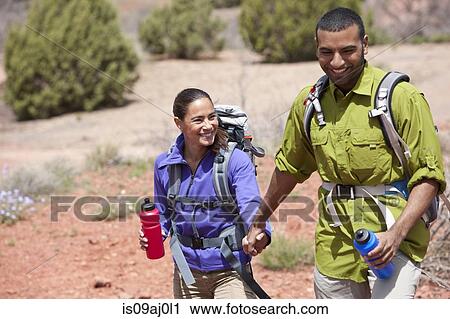 Couple holding hands out hiking, Sedona, Arizona, USA View Large Photo Image Stock Image - Couple holding hands out hiking, Sedona, Arizona, USA. Fotosearch