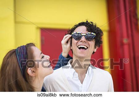 Couple trying on fun sunglasses View Large Photo Image Stock Image - Couple trying on fun sunglasses. Fotosearch